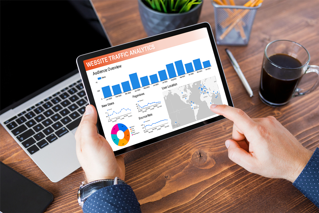person looking at website traffic analytics on tablet