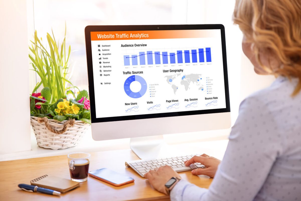 woman viewing website traffic analytics on computer