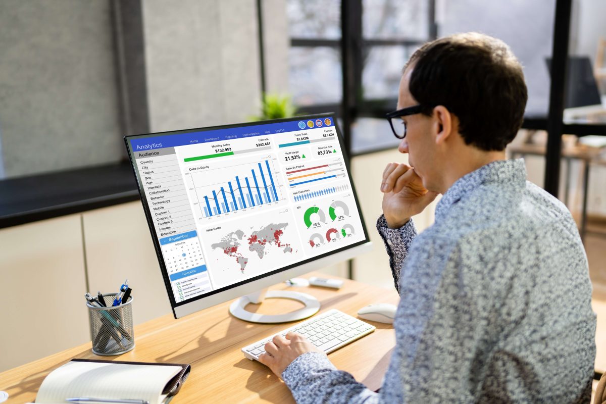 man looking at analytics on computer